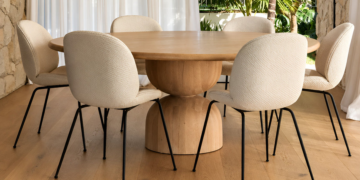 Hourglass dining table with upholstered dining chairs